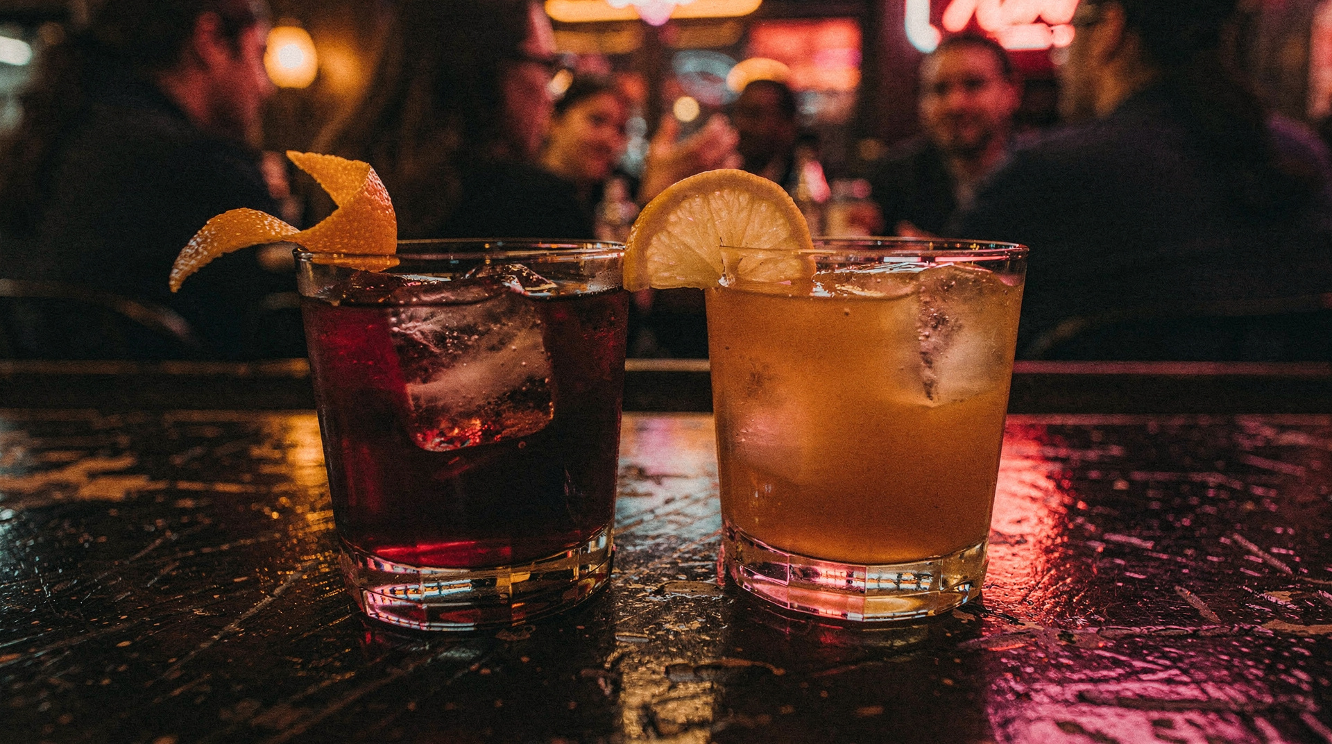 Two cocktails on a bar table